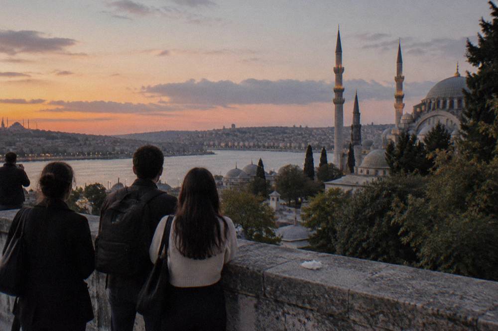 A guided group pausing at a viewpoint above the Golden Horn at dusk