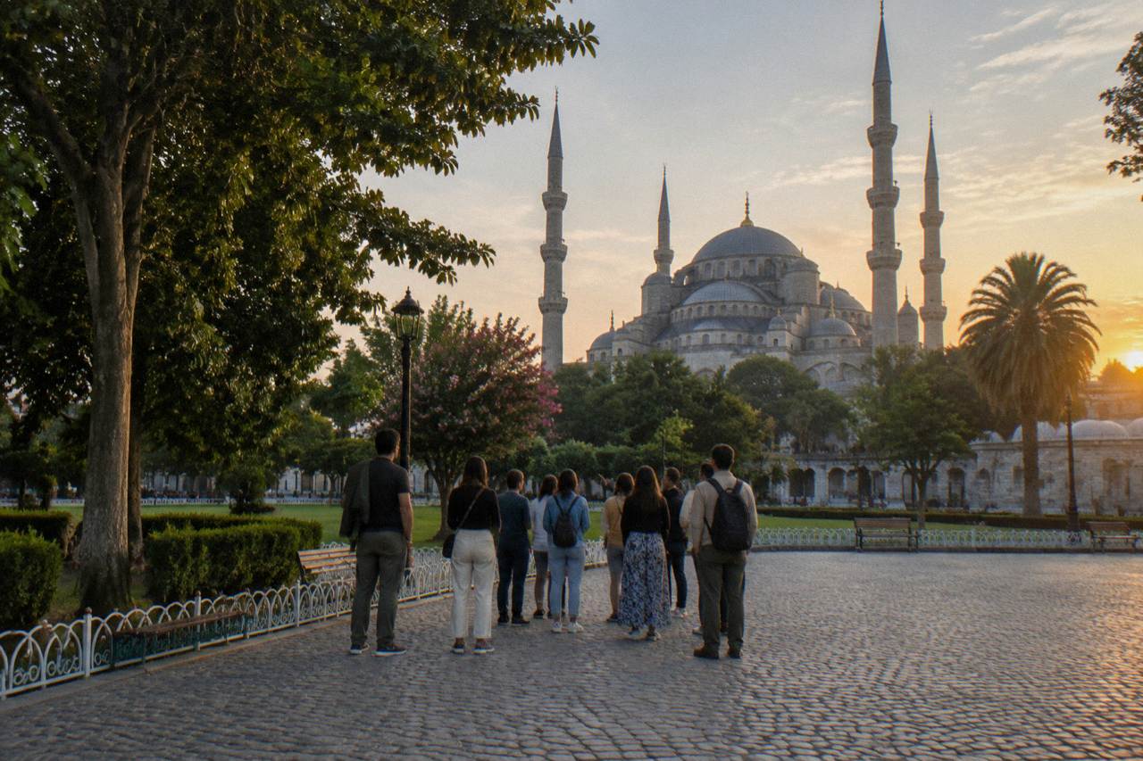 A walking tour group gathered around a guide near the Blue Mosque in Istanbul's Sultanahmet district