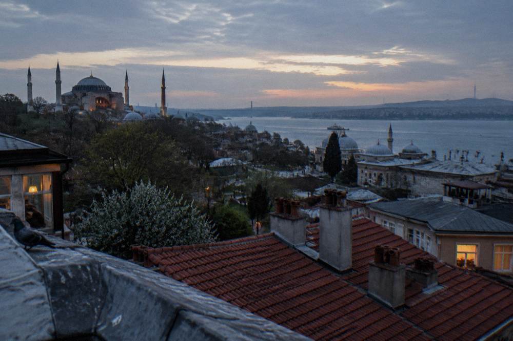 A rooftop view over Istanbul rooftops with the Bosphorus waterway in the distance