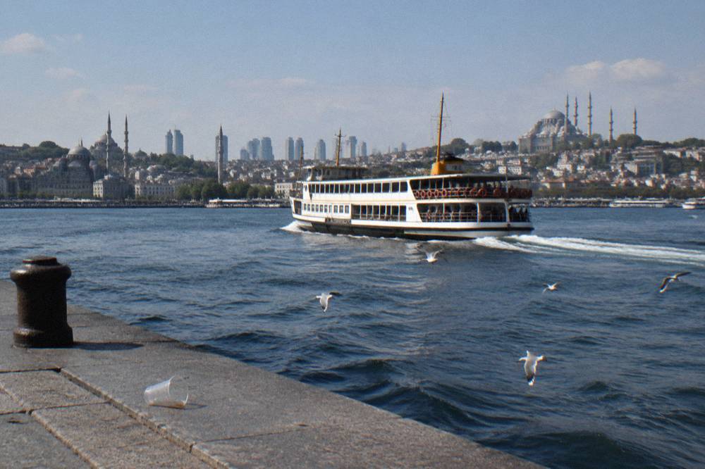Commuter ferry crossing the Bosphorus with the city skyline behind it
