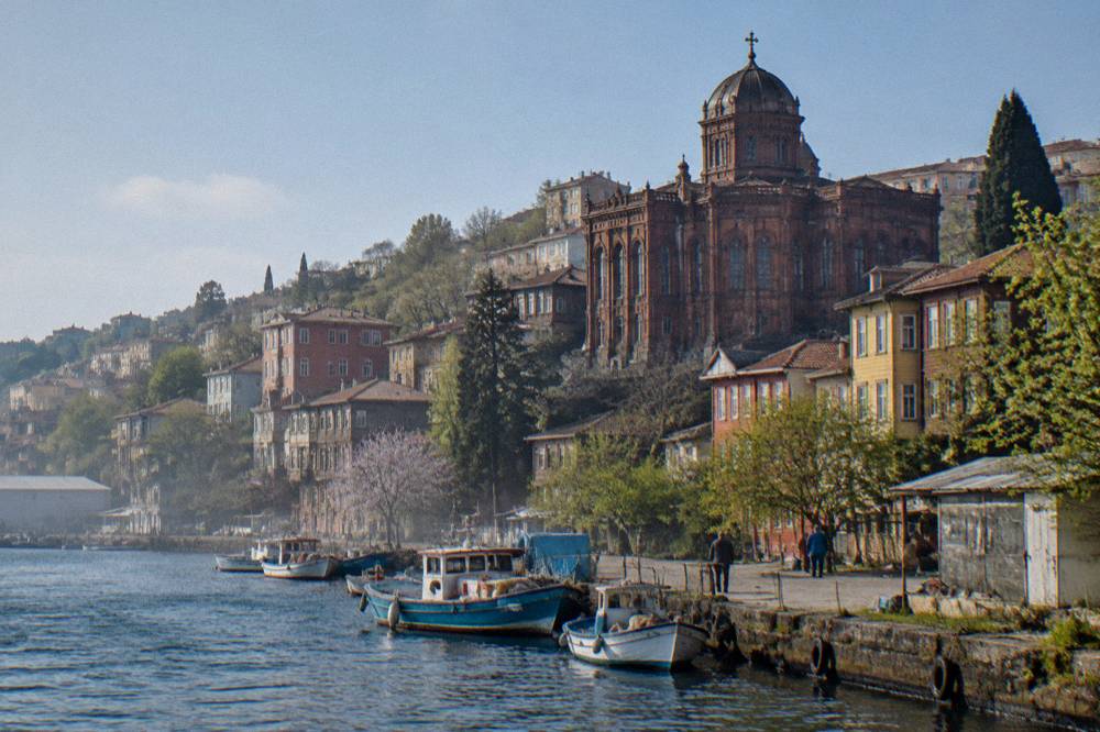 Hillside neighbourhood in Istanbul with buildings descending toward the Bosphorus water
