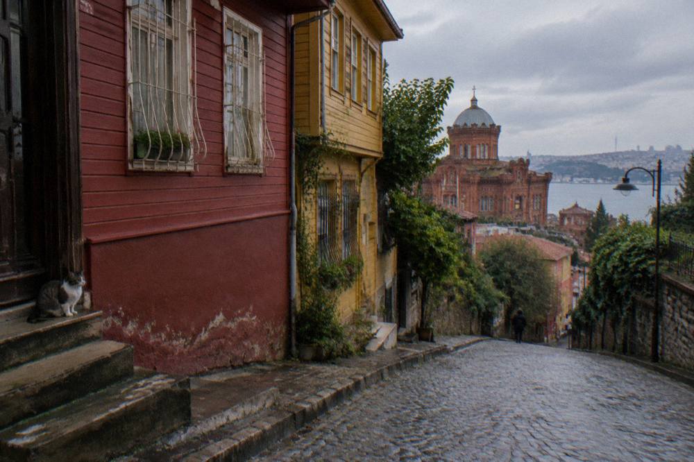 Row of brightly painted historic houses on a steep Balat street