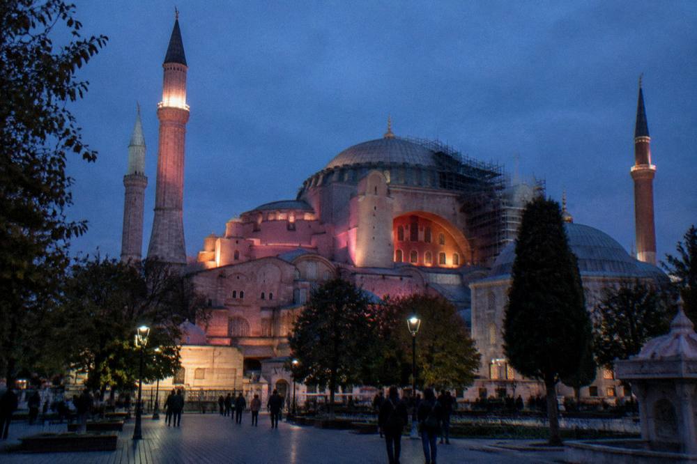 Meeting point square in the Old City at dusk with the Hagia Sophia dome covered in scaffolding