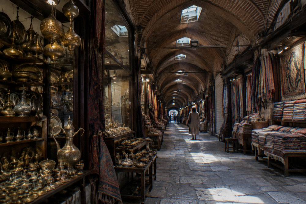 Covered bazaar corridor in Istanbul with shopfronts and light from the ceiling