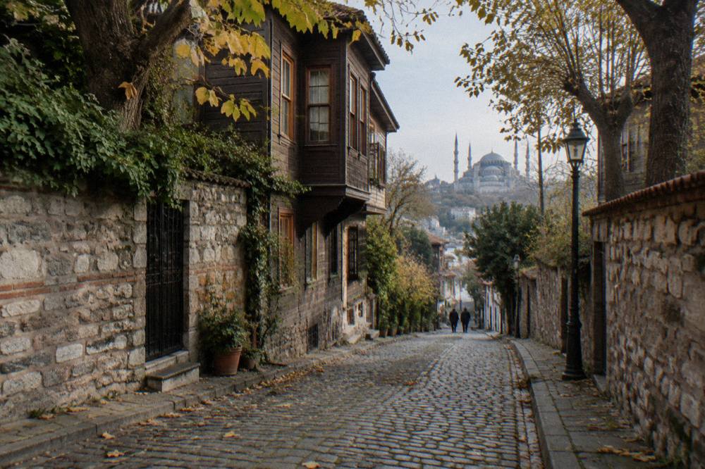 A narrow cobblestone street in Istanbul's old city lined with stone buildings