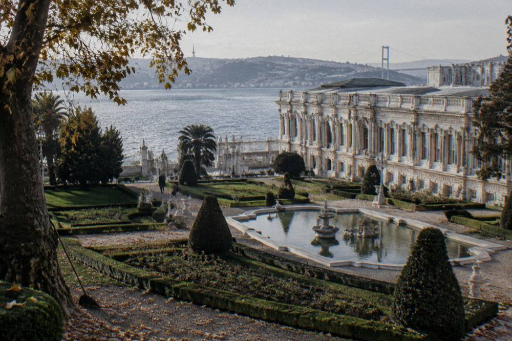 Wooded palace courtyard with tiled walls and a view over the water