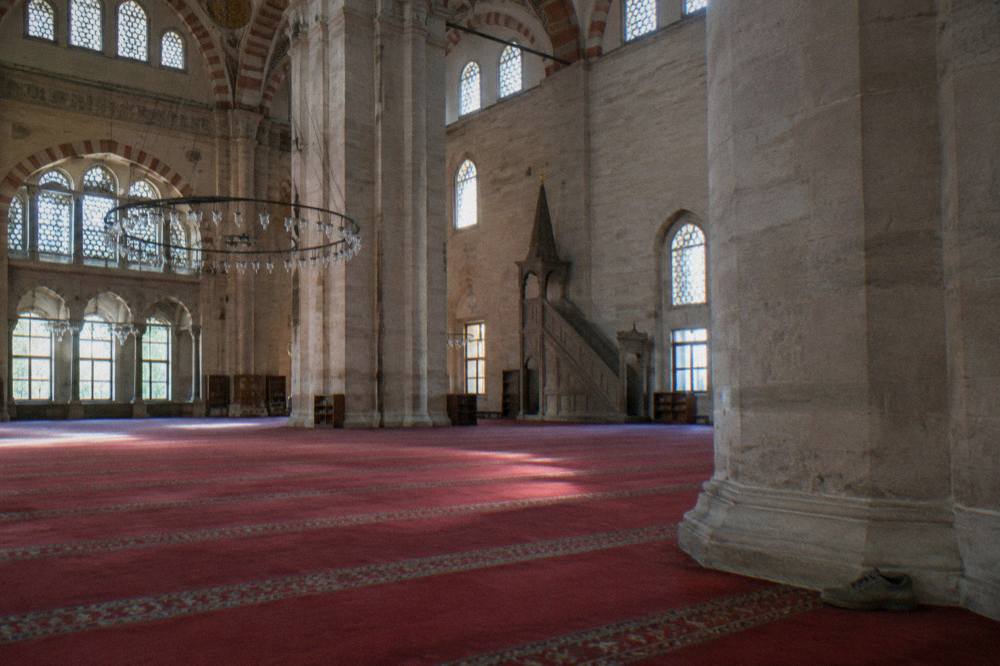 Interior of Suleymaniye Mosque with carpets, columns and light from high windows