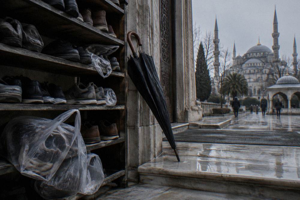 Row of shoe racks and covered shoe bags at the entrance of a large Istanbul mosque